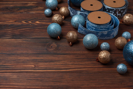 Christmas composition. Christmas balls, blue and silver decorations on blue wooden background. Flat lay. Top view. Copy spaceの写真素材
