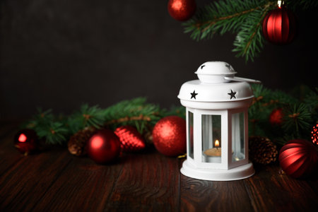Christmas lantern with decorations on dark wooden background. Christmas decoration