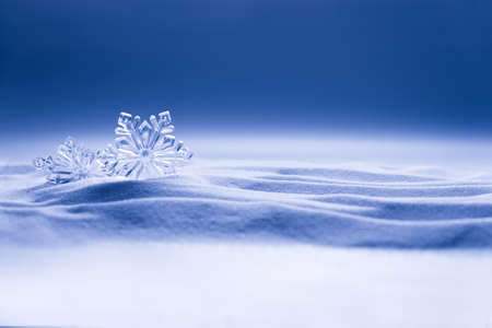 Decorative snowflakes on white snow. Winter holidays backgroundの写真素材