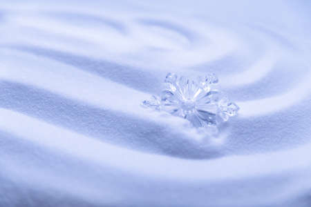 Decorative snowflakes on white snow. Winter holidays backgroundの写真素材
