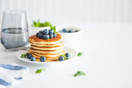 Homemade baked ricotta pancakes with fresh berries on white wooden tableの写真素材