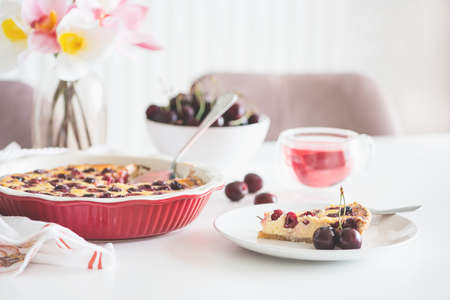Plate with tasty cherry cheesecake pie on white backgroundの写真素材