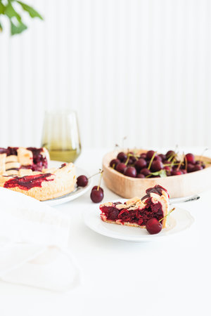 Plate with tasty American cherry pie on white background. Top view. Copy space