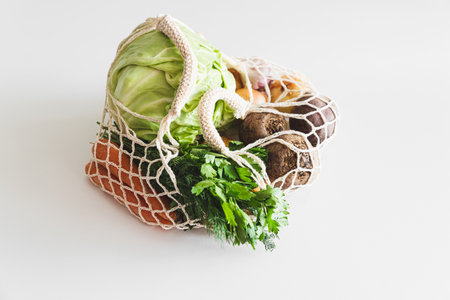 String bag with ingredients for preparing ukrainian borscht on white background. Top viewの写真素材