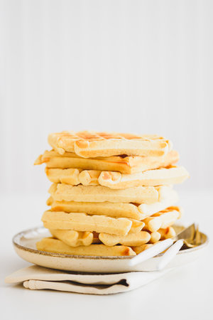Stack of Belgian waffles on white tableの写真素材