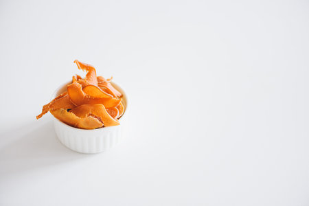 Organic apple cinnamon chips on white wooden table