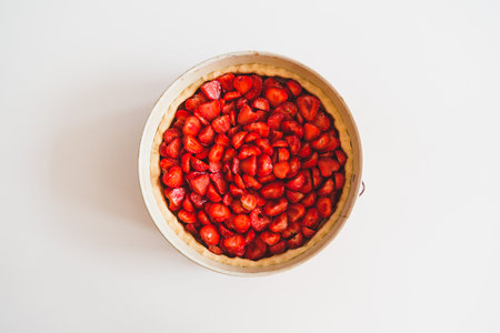 Strawberry cake on white table. Top view