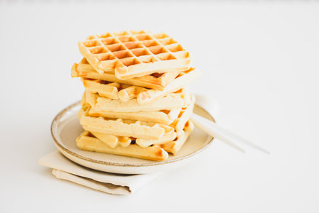 Stack of Belgian waffles on white tableの写真素材