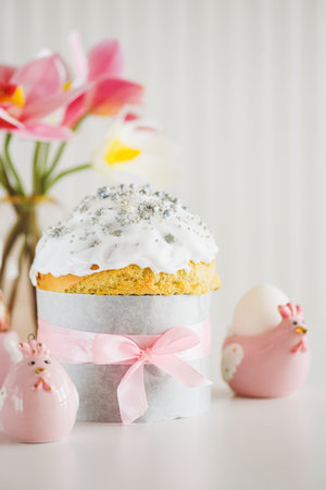 Traditional Easter cakes or sweet bread with hen figurines and eggs on white table. Front viewの写真素材