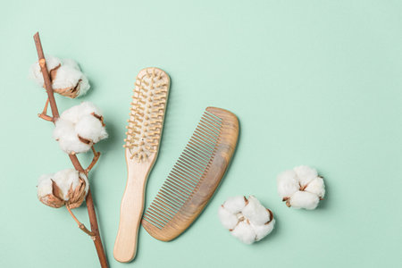 Eco friendly self care products concept. Bamboo comb and brush on soft green background. Top viewの写真素材
