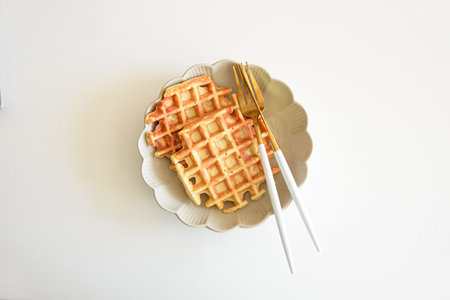 Freshly baked apple Belgian waffles on white tableの写真素材
