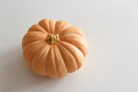 Orange pumpkin on white wooden table. Top viewの写真素材