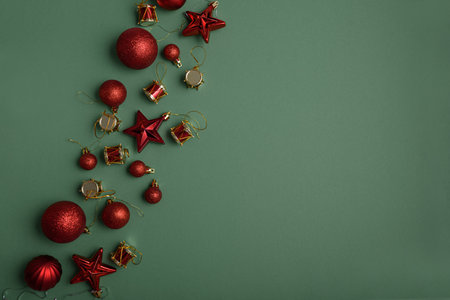 Green Christmas background with red stars, balls end different xmas toys. Christmas and Happy New Year celebration conceptの写真素材