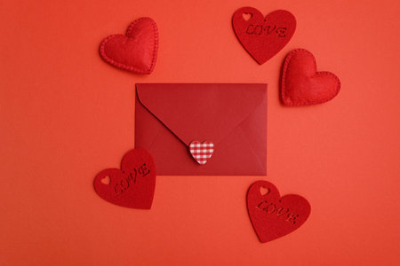 Close red envelope with hearts on red background. Valentines day celebration