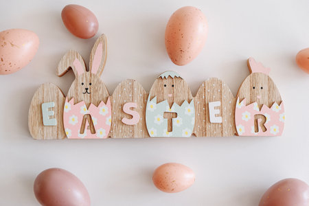 Easter decoration with easter eggs on white table. Top view