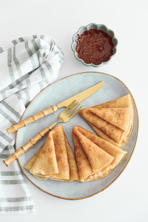 Crepes with chocolate cream and coffee on white wooden table. Pancake day, Maslenitsa. Top view