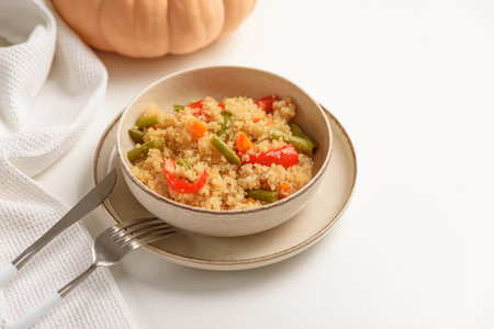Quinoa vegetable salad on white wooden table. Vegetarian and diet foodの写真素材