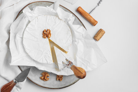 Cutted fresh brie cheese with walnuts on white table. Top viewの写真素材