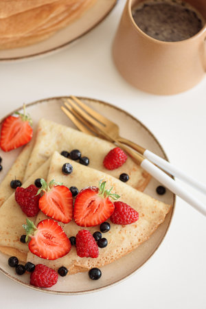 Fresh crepes with mixed berries and coffee.の写真素材
