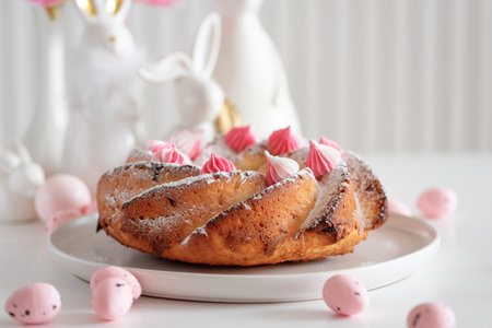 Traditional Easter cakes with icing decorated candies on white wooden table