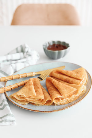Crepes with chocolate cream and coffee on white wooden table. Pancake day, Maslenitsaの写真素材