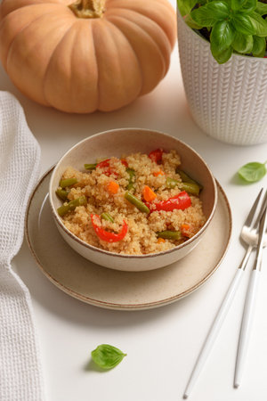 Quinoa vegetable salad on white wooden table. Vegetarian and diet foodの写真素材
