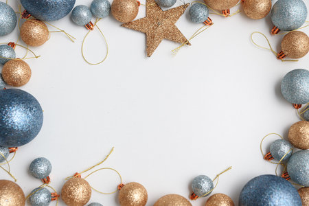 Blue, golden ornaments and Christmas lights on white background. Top viewの写真素材