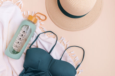 Beach essentials including swimwear, hat, towel, and water bottle.