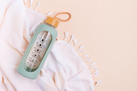 Water bottle and towel on a light background.の写真素材