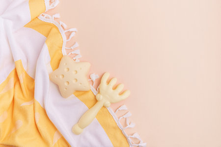 Beach toys and a striped towel on a light background.の写真素材