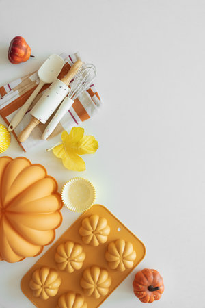 Autumn Baking Setup with Pumpkin Mold, Frosting and Seasonal Decorationsの写真素材