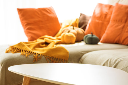 Empty coffee table into autumnal living room decor with corduroy pumpkins and cozy pillowsの写真素材