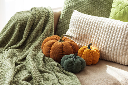 Cozy Autumn Sofa with Fabric Pumpkins and Textured Pillowsの写真素材