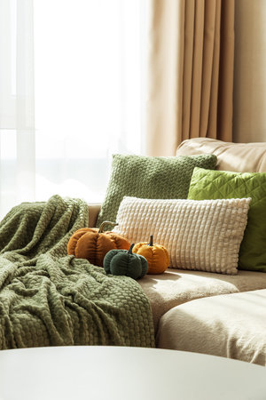 Cozy Autumn Sofa with Fabric Pumpkins and Textured Pillowsの写真素材