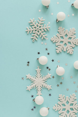 White Christmas Ornaments and Snowflakes on Light Blue Backgroundの写真素材