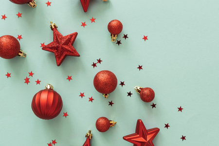 Red Christmas Ornaments and Confetti on Light Blue Background
