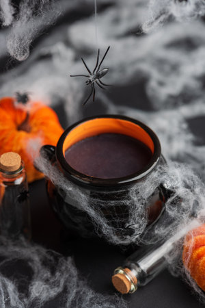 Halloween Cauldron with Pumpkins, Spiders and Cobwebsの写真素材