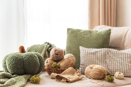 Knitting Basket with Yarn and Velvet Pumpkins in Cozy Autumn Sofaの写真素材