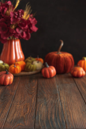 Defocused autumnal composition of decorative mini pumpkins on a wooden surface. Mock-upの写真素材