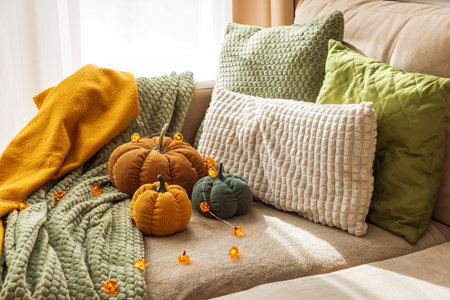Cozy Autumn Living Room with Corduroy Pumpkins and Textured Blanketsの写真素材