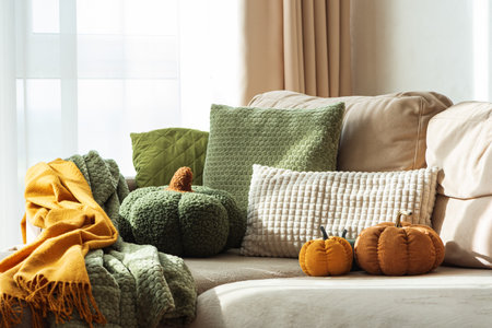 Autumn Sofa Styling with Textured Pillows, Fabric Pumpkins, and Cozy Blanketsの写真素材