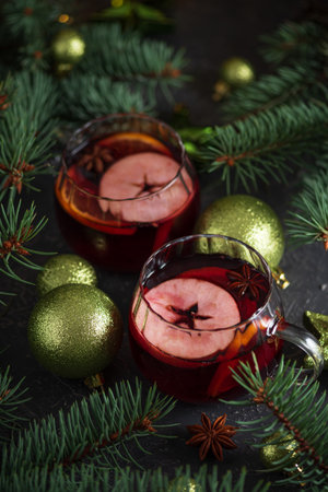 Two Glass Mugs of Mulled Wine with Christmas Decor and Fairy Lightsの写真素材