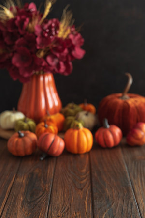 Defocused autumnal composition of decorative mini pumpkins on a wooden surface. Mock-upの写真素材