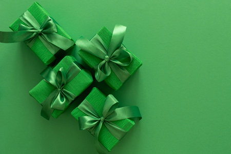 Green Gift Boxes on Solid Green Background with Copy Spaceの写真素材