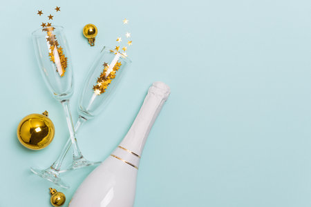 Festive Champagne Celebration with Gold Ornaments and Star Confettiの写真素材