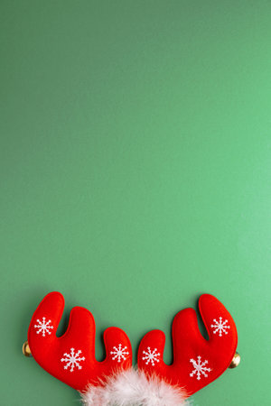 Christmas Reindeer Antler Headband with Snowflakes on Green Backgroundの写真素材