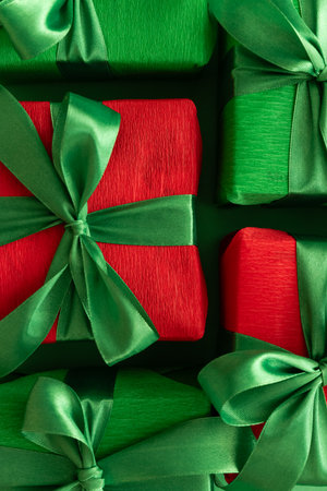 Close-up Christmas Green and Red Gift Boxes on Green Backgroundの写真素材