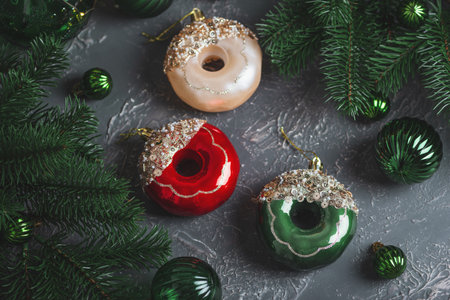 Festive Donut-Shaped Christmas Ornaments with Glitter and Pine Decorの写真素材