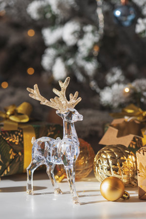 Crystal Reindeer with Gold Antlers and Christmas Gifts in Festive Interiorの写真素材