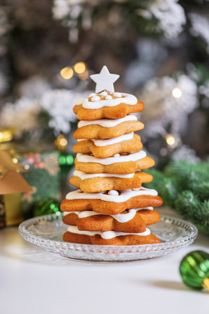 Christmas Tree Cookie Stack with Icing and Ornaments on White Tableの写真素材